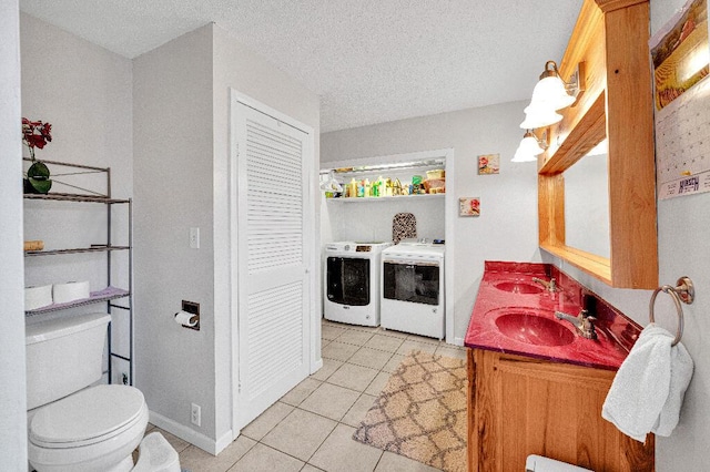 bathroom featuring washing machine and dryer, tile patterned flooring, a textured ceiling, toilet, and vanity