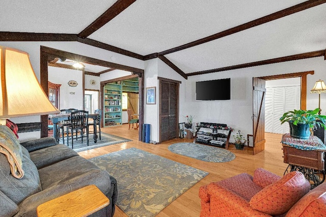 living room featuring vaulted ceiling with beams and light hardwood / wood-style flooring