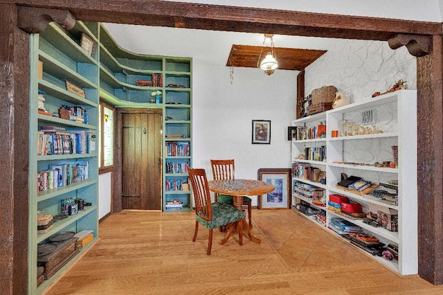 interior space with beamed ceiling and hardwood / wood-style flooring