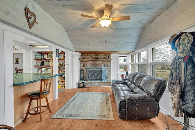 living room featuring wood ceiling, built in features, wood-type flooring, and lofted ceiling