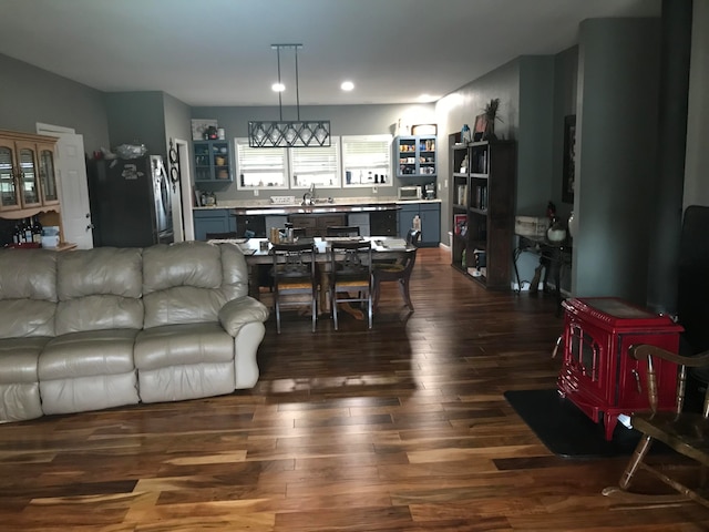 living room featuring sink and dark hardwood / wood-style flooring