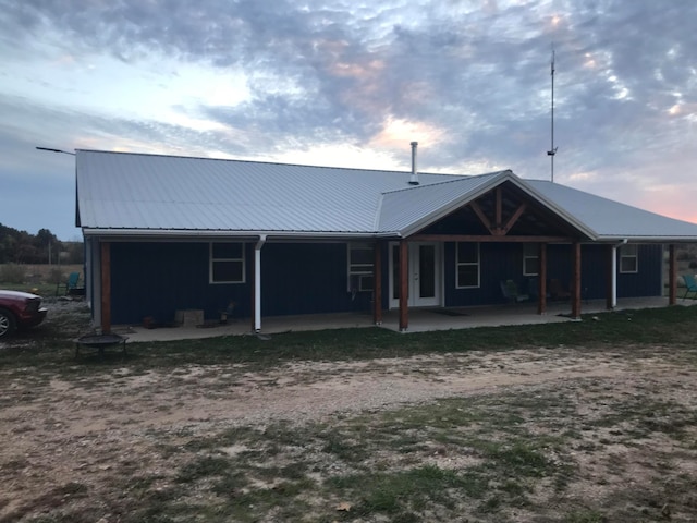 view of back house at dusk