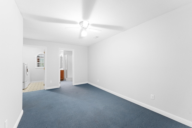 unfurnished bedroom with washer / dryer, ceiling fan, connected bathroom, and dark carpet