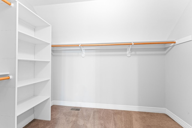 walk in closet with carpet flooring