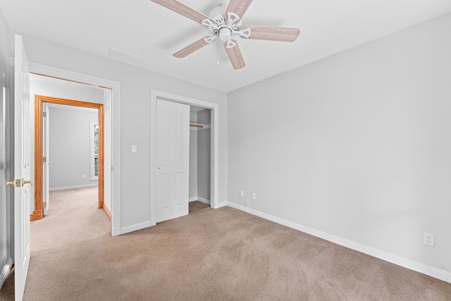 unfurnished bedroom featuring carpet floors, a closet, a ceiling fan, and baseboards