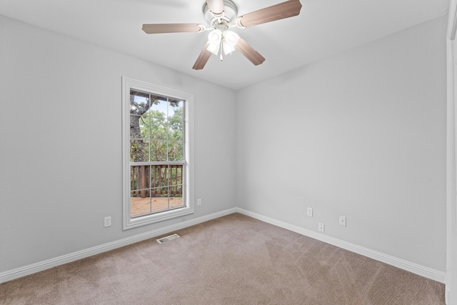 empty room featuring baseboards, a ceiling fan, visible vents, and carpet