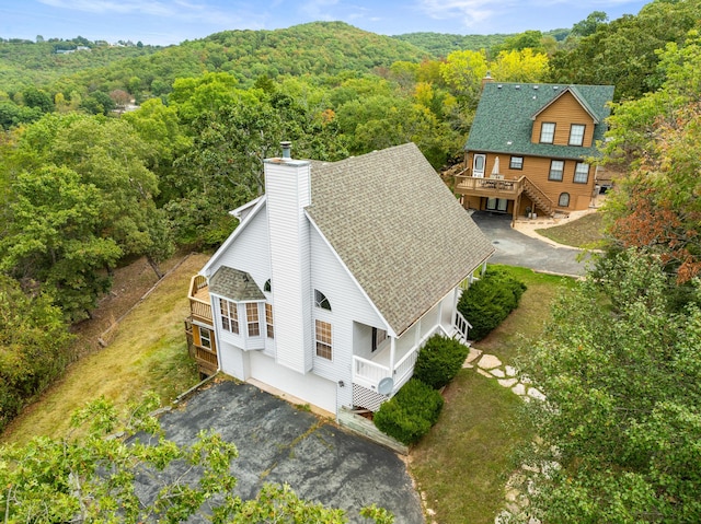 birds eye view of property with a view of trees