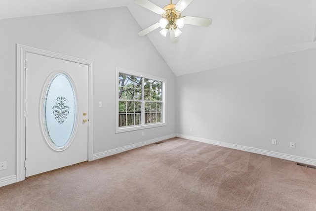 carpeted entryway featuring baseboards, a ceiling fan, visible vents, and high vaulted ceiling