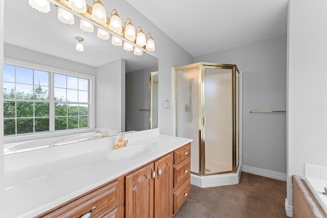 bathroom with vanity, shower with separate bathtub, and vaulted ceiling