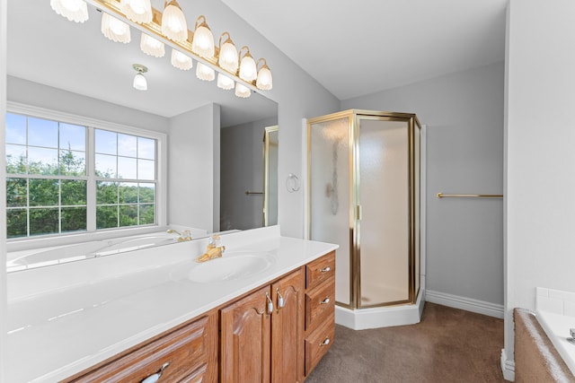 full bathroom with a bath, baseboards, vanity, and a stall shower