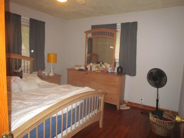 bedroom with dark wood-type flooring