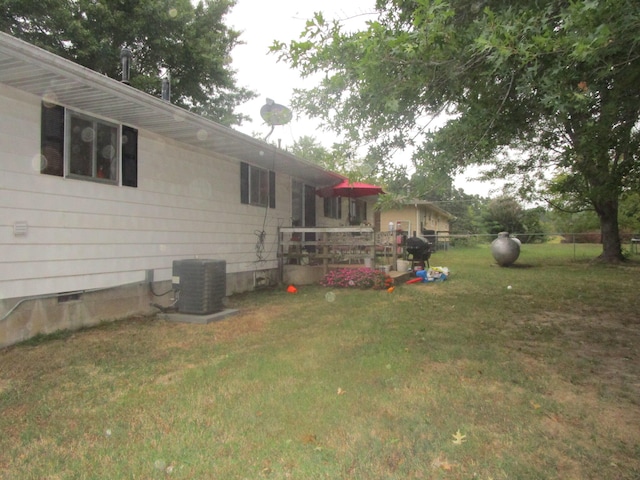 view of yard featuring central air condition unit