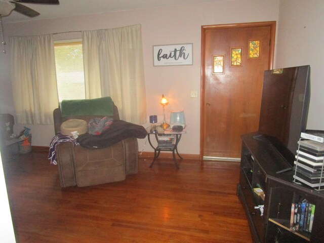 living room with ceiling fan and dark hardwood / wood-style flooring