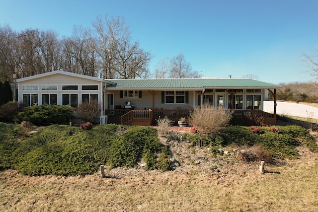 view of front of house with a sunroom