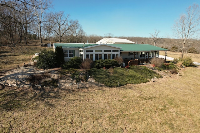 rear view of house with a lawn and covered porch