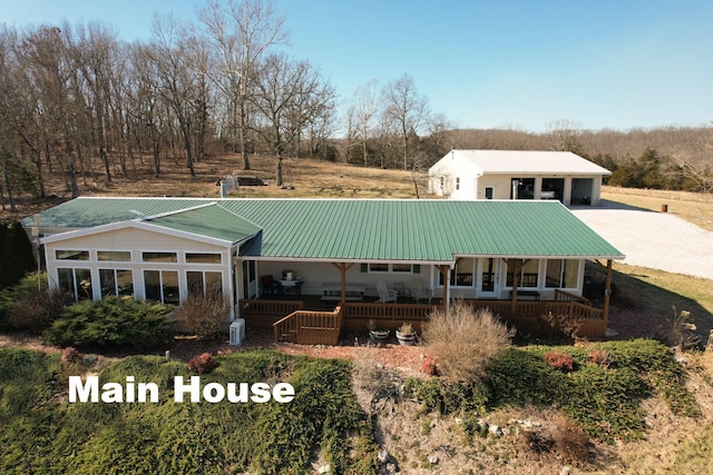 back of property featuring covered porch