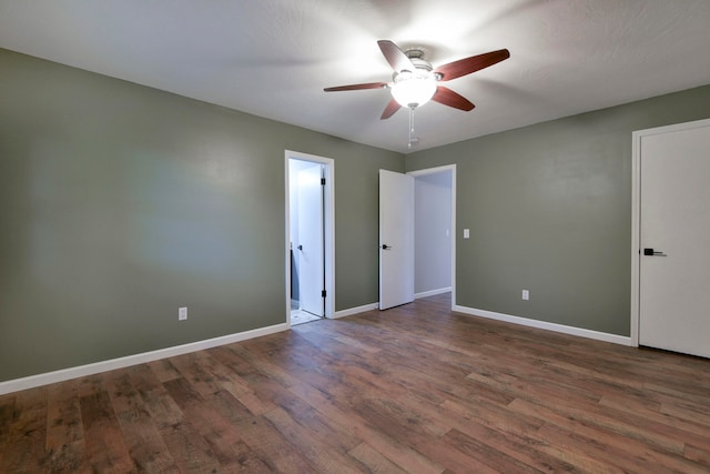 unfurnished bedroom with dark hardwood / wood-style flooring and ceiling fan