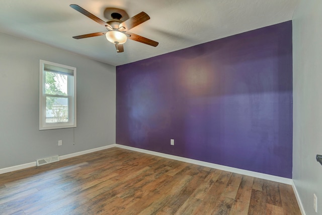 spare room with hardwood / wood-style flooring and ceiling fan