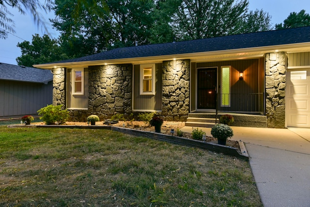 ranch-style home with a front yard and a garage