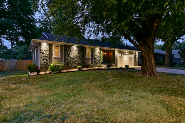 single story home with a front yard and a garage