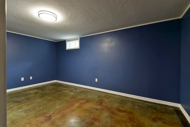 spare room with a textured ceiling, crown molding, and concrete floors