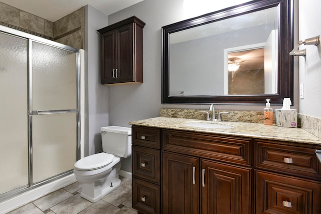 bathroom featuring tile patterned flooring, vanity, walk in shower, and toilet