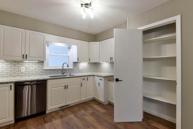 kitchen featuring white cabinets, sink, stainless steel dishwasher, dark wood-type flooring, and light stone countertops