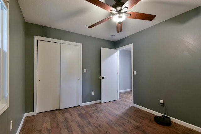 unfurnished bedroom with ceiling fan, a closet, and wood-type flooring