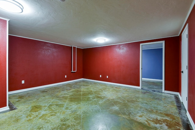 spare room with ornamental molding and a textured ceiling