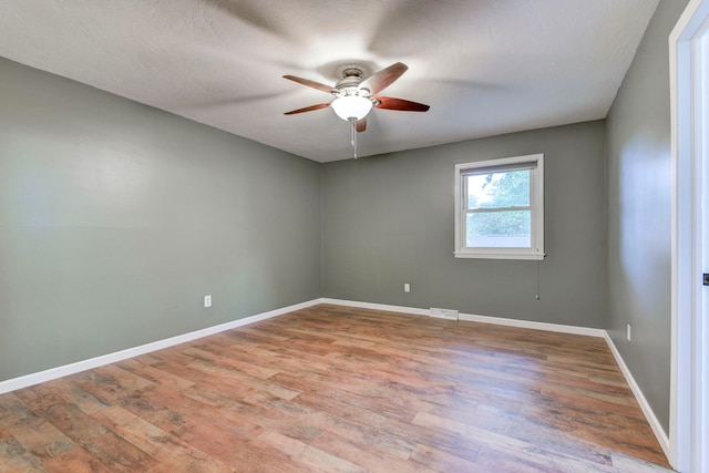 empty room featuring ceiling fan and wood-type flooring