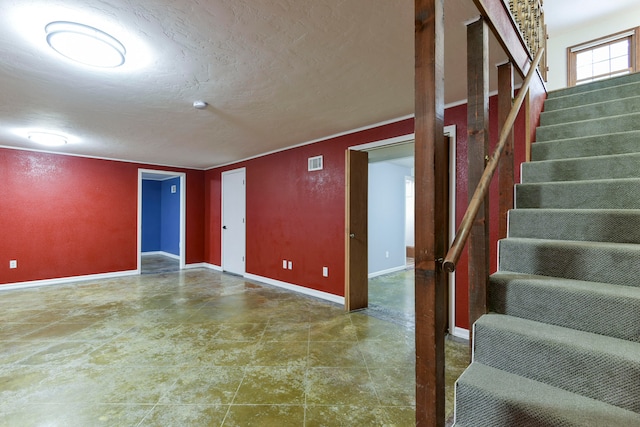 basement featuring a textured ceiling