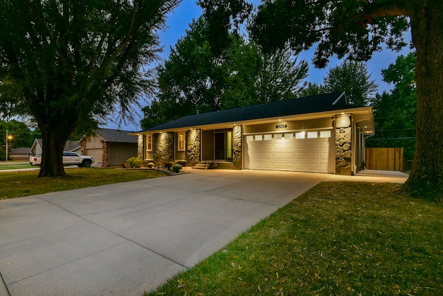 ranch-style home featuring a front yard and a garage