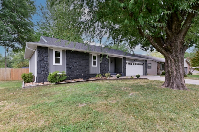 single story home with a front yard and a garage