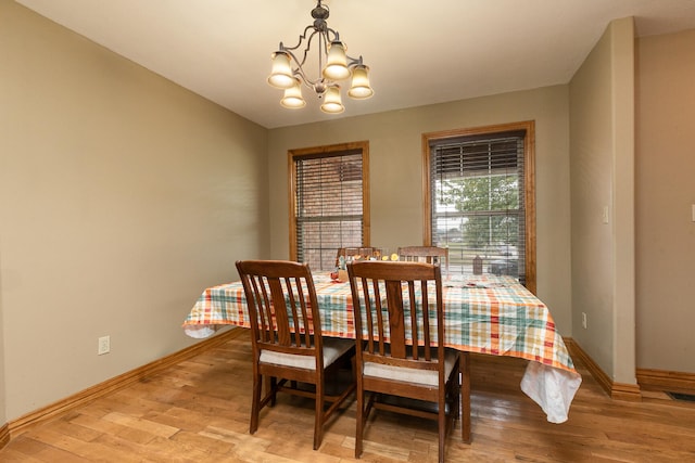 dining room featuring an inviting chandelier and light wood-type flooring