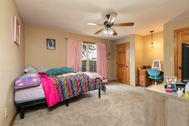 bedroom featuring ceiling fan and light carpet