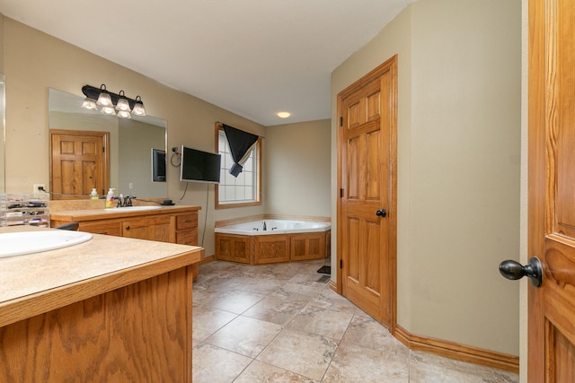 bathroom featuring vanity, tile patterned flooring, and a tub