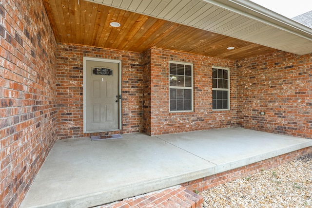 view of exterior entry featuring a patio area