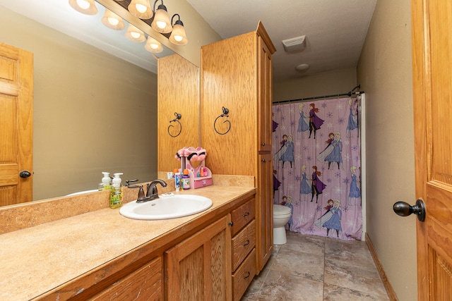 bathroom featuring toilet, vanity, and a shower with shower curtain