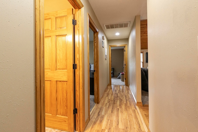 hallway with light hardwood / wood-style flooring