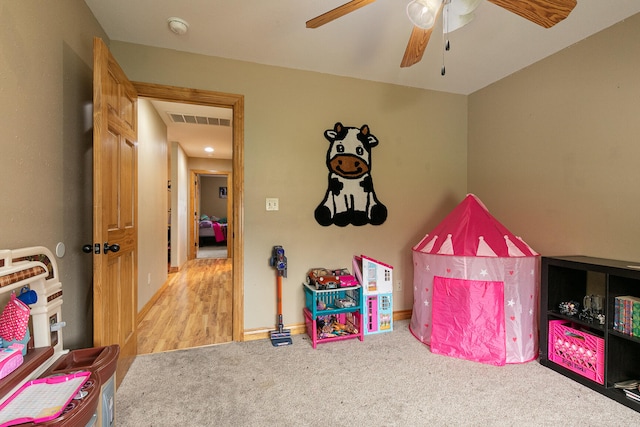 recreation room featuring ceiling fan and light wood-type flooring