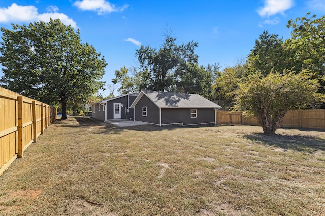 back of property featuring a patio and a lawn