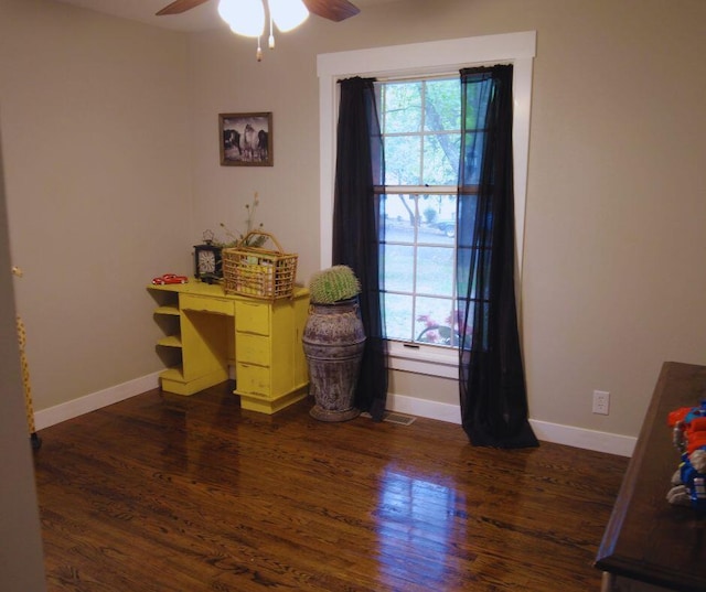 home office with ceiling fan, plenty of natural light, and dark wood-type flooring