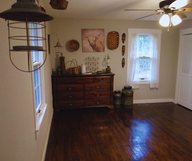 bedroom featuring ceiling fan, baseboards, and dark wood-style flooring