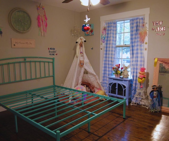 bedroom with ceiling fan and dark wood-type flooring