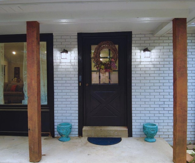 view of exterior entry with covered porch