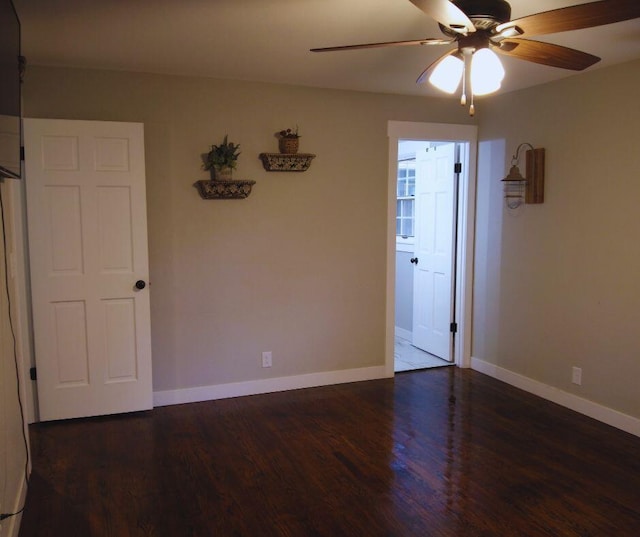 unfurnished room with baseboards, a ceiling fan, and wood finished floors