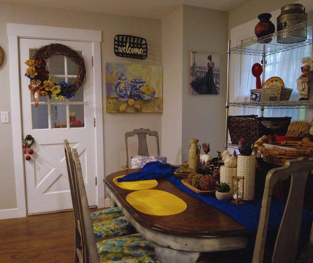 dining area featuring baseboards and wood finished floors
