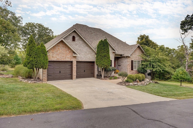 view of front of property with a front lawn and a garage