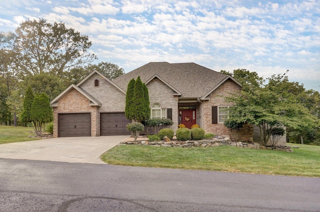 view of front of property featuring a garage and a front yard