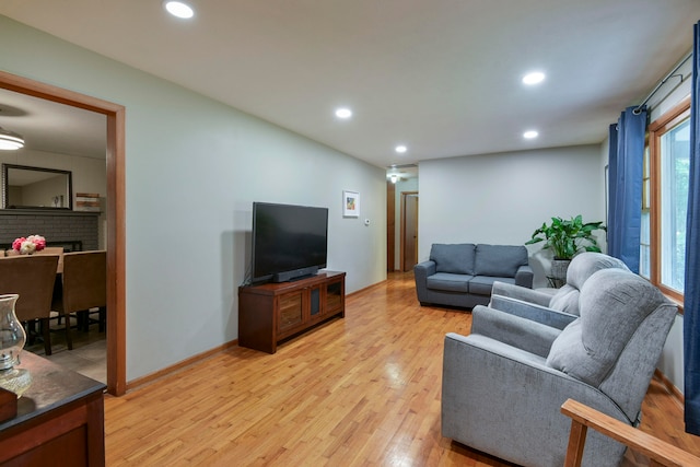 living room featuring light hardwood / wood-style flooring and a fireplace